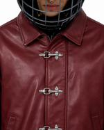 Maroon leather jacket close-up with pointed collar and triple toggle clasps