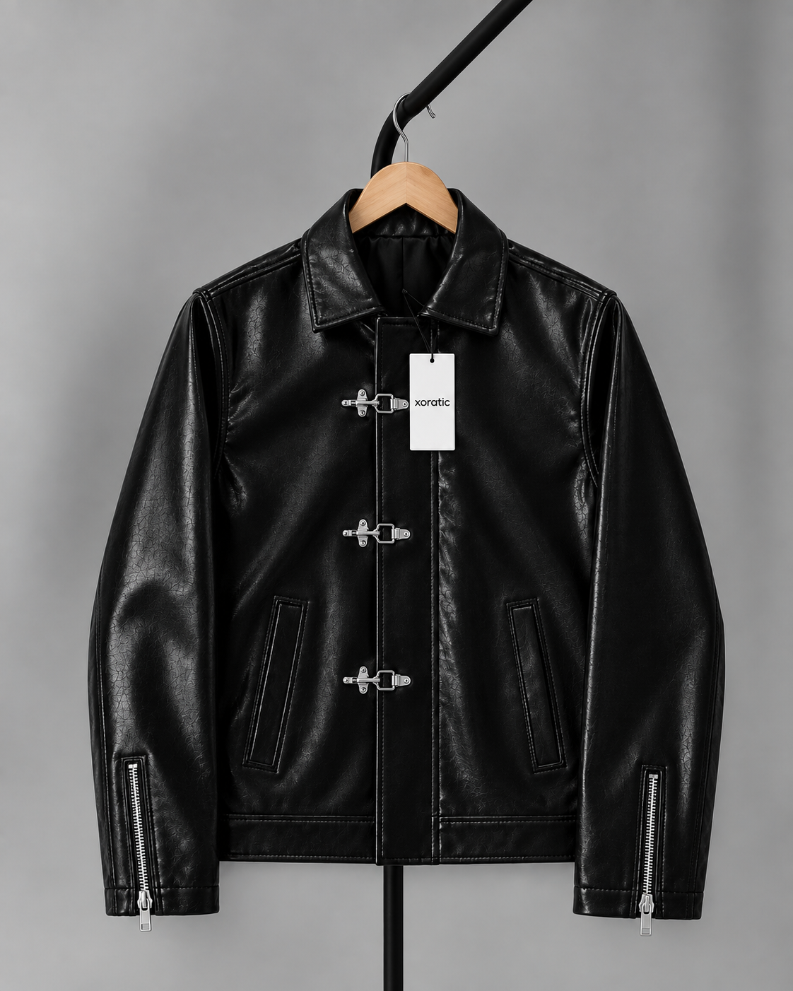 Black faux leather jacket with fireman clasp hardware, stand collar, zip front, flap pockets