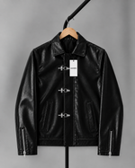 Black faux leather jacket with fireman clasp hardware, stand collar, zip front, flap pockets