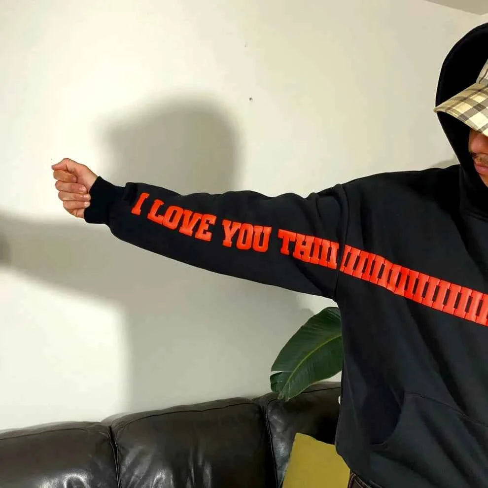 Elevate Your Style with the I Love You This Much Hoodie in Black by Xoratic, a black Hoodie featuring bold red lettering along the sleeve and chest