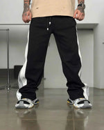 Black zip up jogger pants by Xoratic