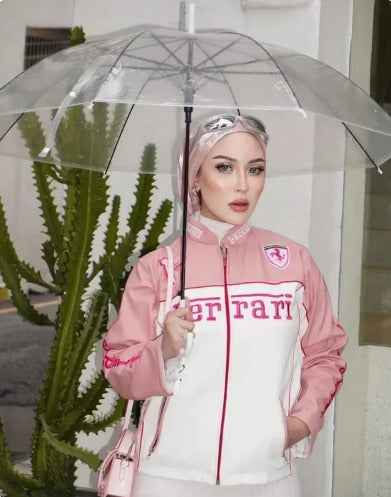 Chic Pink Ferrari Racing Jacket for Girls - Embroidered & Stylish worn by a model under a clear umbrella, featuring white panels and Ferrari branding by Xoratic